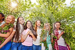 Smiling teenage girls standing and holding benches