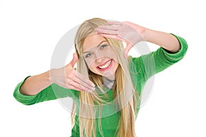 Smiling teenage student girl framing with hands