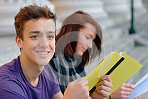 Smiling teenage students outdoors