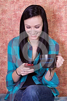 Smiling Teenager Drinking Coffee and Texting