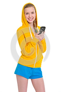 Smiling teenager girl writing sms