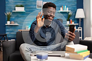 Smiling teenager greeting remote collegue discussing marketing ideas