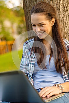 Smiling teenager with laptop