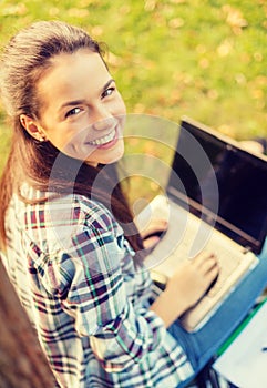 Smiling teenager with laptop