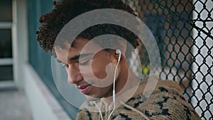 Smiling teenager listening song in headphones at quiet urban area closeup.