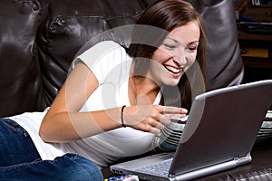 Smiling Teenager Looking at the Computer