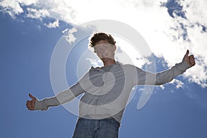 Smiling teenager posing both thumbs up