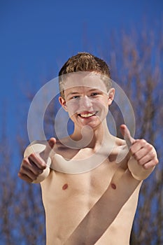 Smiling teenager posing thumbs up