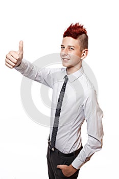 A smiling teenager shows his thumb up isolated on the white background