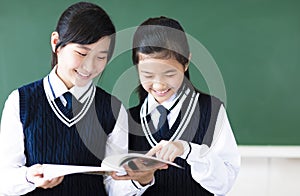 Smiling teenager student girls in classroom