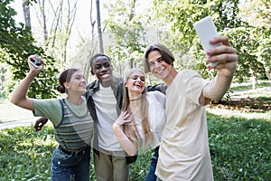 Smiling teenager taking selfie with interracial