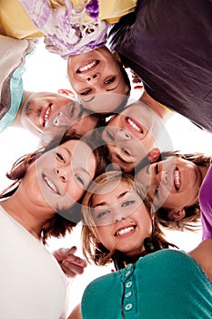 Smiling teenagers in circle