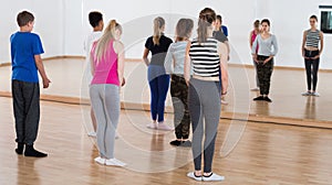 Smiling teenagers practicing in ballet school