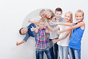 The smiling teenagers showing okay sign on white