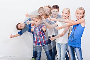 The smiling teenagers showing okay sign on white