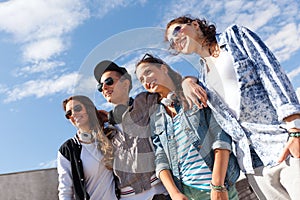 Smiling teenagers in sunglasses hanging outside