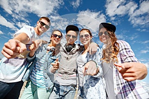 Smiling teenagers in sunglasses hanging outside