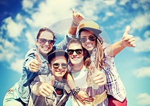 Smiling teenagers in sunglasses hanging outside