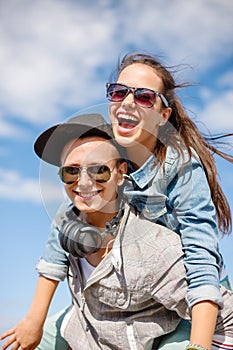 Smiling teenagers in sunglasses having fun outside