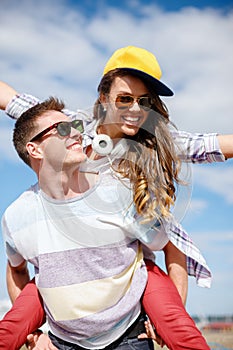 Smiling teenagers in sunglasses having fun outside