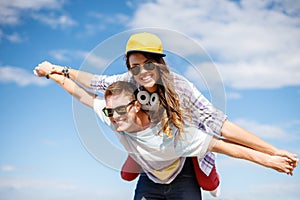 Smiling teenagers in sunglasses having fun outside