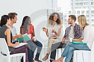 Smiling therapist speaking to a rehab group