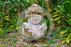 Smiling tiki. Carved stone Polynesian sacred idol statue. Raivavae island, Astral islands, French Polynesia, Oceania. photo