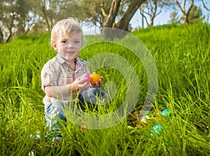 Smiling toddler boy in Easter hunt