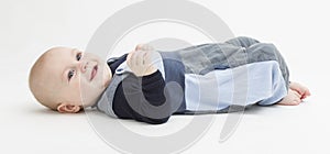 Smiling toddler laying on his back