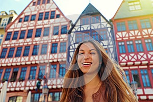 Smiling tourist woman in Romerberg square, Frankfurt, Germany photo