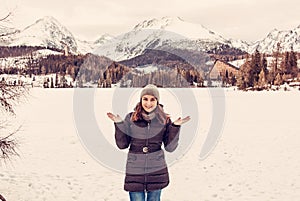 Smiling tourist woman in Strbske pleso resort, Slovakia, red filter