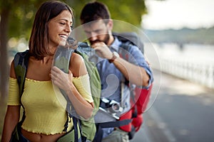 Smiling tourists enjoying on vacation,  couple having fun walking on city street