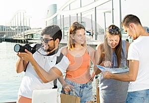 smiling tourists looking at the map