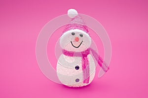 Smiling toy christmas snowman on red background