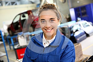 Smiling trainee in repairshop