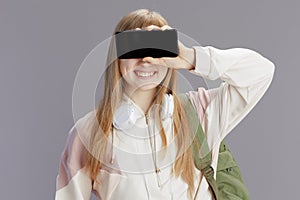 smiling trendy teenage girl showing smartphone blank screen