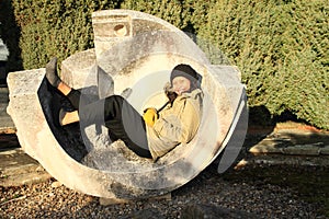 Smiling tropical girl lying in sun-dial