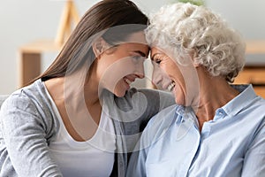 Smiling two generation women family laughing bonding cuddling together