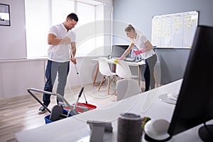 Smiling Two Young Janitor Cleaning The Office