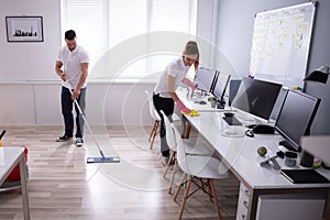 Smiling Two Young Janitor Cleaning The Office