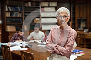 Smiling university professor in library