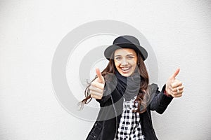 Smiling urban girl with smile on her face. Portrait of fashionable gir wearing a rock black style having fun outdoors in the city