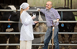 Smiling veterinarian chatting with farmer