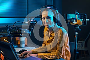 Smiling video blogger recording in the studio