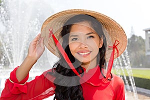 Smiling Vietnamese woman in a red Ao Dai photo