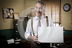 Smiling vintage businessman holding a blank sign