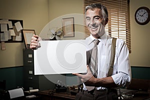 Smiling vintage businessman holding a blank sign