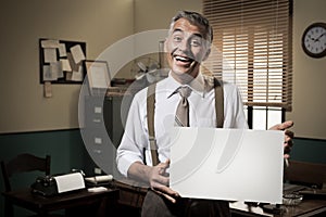Smiling vintage businessman holding a blank sign