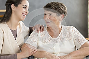 Smiling volunteer and elderly woman