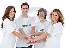 Smiling volunteer group piling up their hands photo